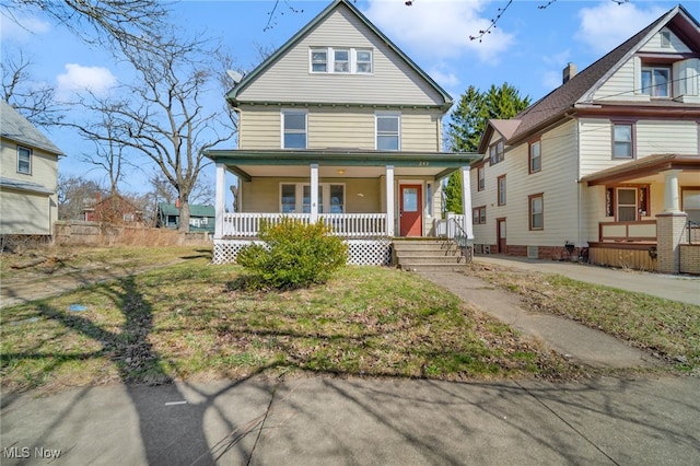 american foursquare style home featuring a porch