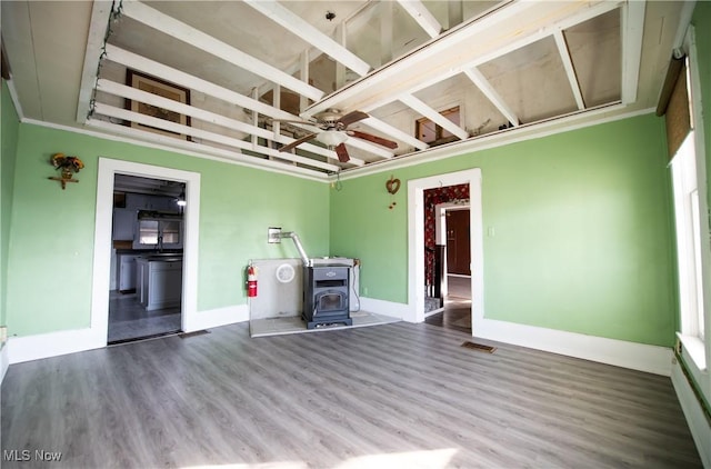 20059 Cadiz Rd, Quaker City, OH 43773 - unfurnished living room featuring a wood stove, wood finished floors, baseboards, and ceiling fan