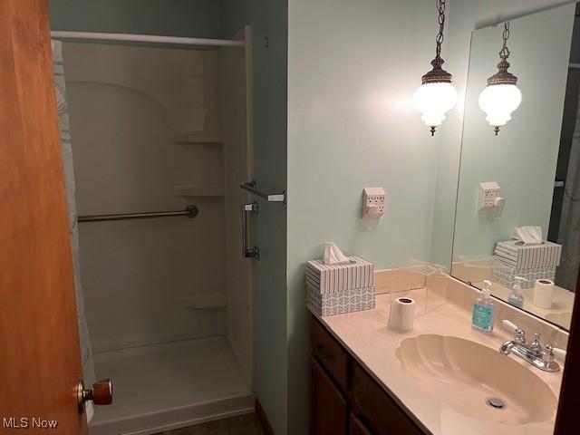 bathroom featuring a stall shower and vanity