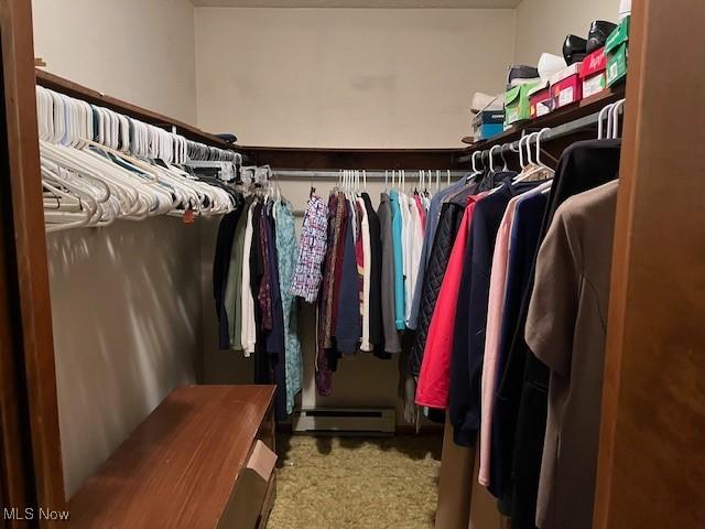 walk in closet with carpet flooring and baseboard heating