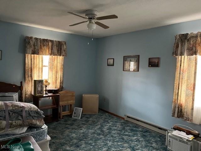 carpeted bedroom with a ceiling fan and a baseboard radiator