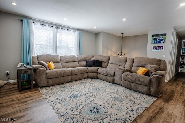 living area with baseboards, dark wood finished floors, and recessed lighting