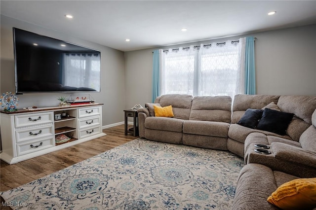 living room with recessed lighting, baseboards, and wood finished floors