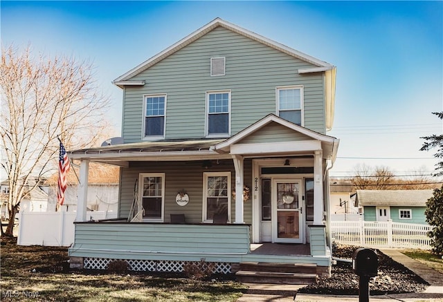 view of front of home with fence and covered porch