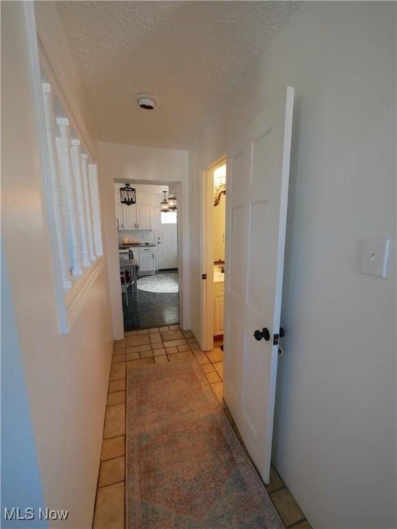 2616 Eldersville Rd, Follansbee, WV 26037 - hall with light tile patterned flooring, a notable chandelier, and a textured ceiling