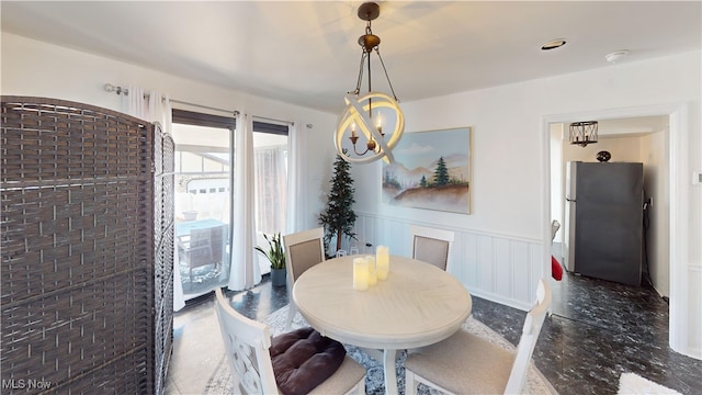 2616 Eldersville Rd, Follansbee, WV 26037 - dining space with an inviting chandelier, a decorative wall, a wainscoted wall, and brick wall