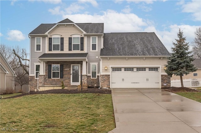 view of front of property featuring stone siding, a front yard, concrete driveway, and an attached garage