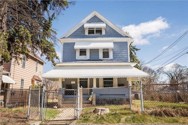 view of front of home with fence and a gate