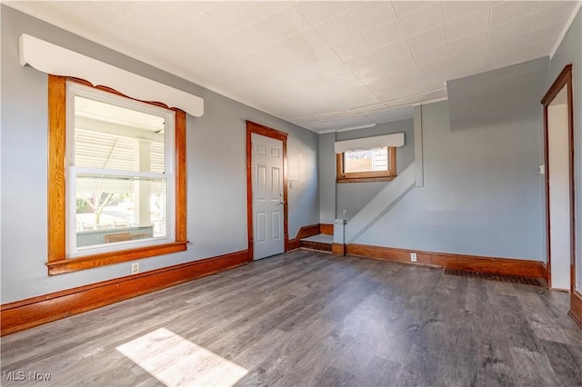 empty room with wood finished floors and baseboards