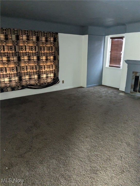3643 Lindholm Rd, Shaker Heights, OH 44120 - unfurnished living room with a fireplace with flush hearth and carpet