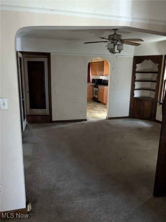 3643 Lindholm Rd, Shaker Heights, OH 44120 - empty room with baseboards, arched walkways, concrete floors, and ceiling fan