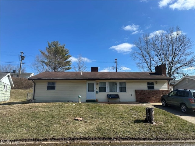 167 Andover Rd, Woodsfield, OH 43793 - back of property with a lawn and a chimney