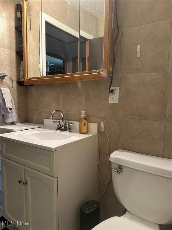 167 Andover Rd, Woodsfield, OH 43793 - half bath featuring tile walls, vanity, backsplash, and toilet