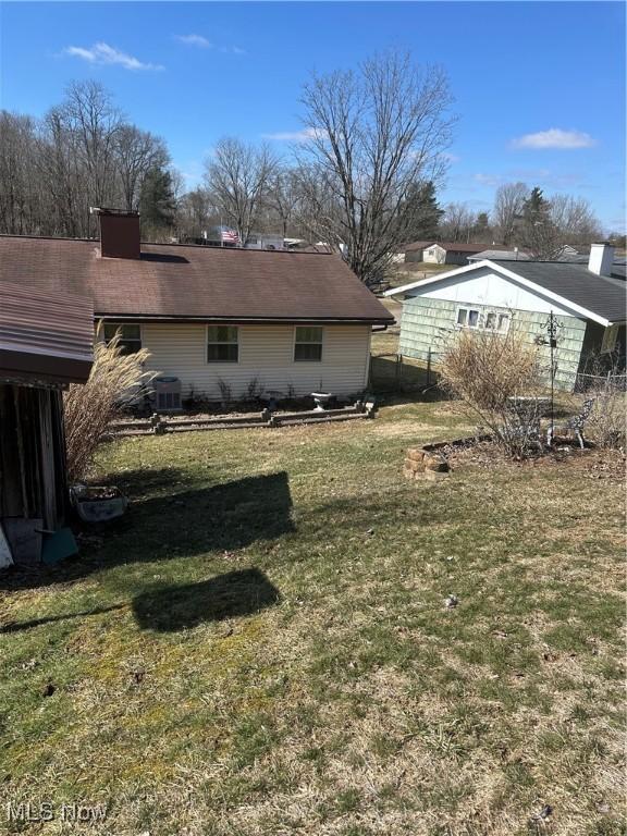167 Andover Rd, Woodsfield, OH 43793 - rear view of house with a lawn and cooling unit