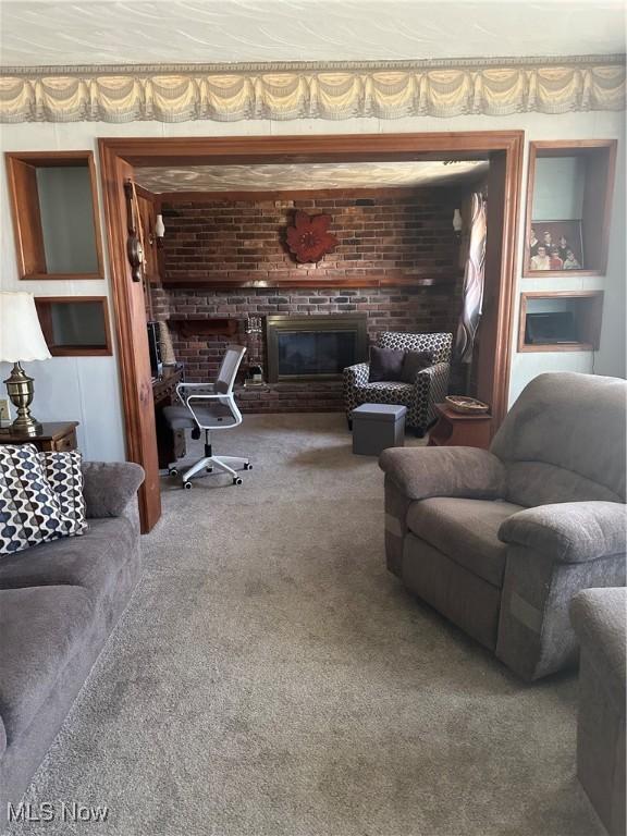 167 Andover Rd, Woodsfield, OH 43793 - carpeted living area featuring a brick fireplace