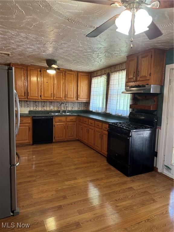167 Andover Rd, Woodsfield, OH 43793 - kitchen featuring black appliances, extractor fan, a sink, and brown cabinets