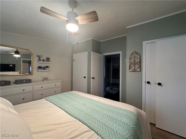 bedroom featuring ceiling fan, ornamental molding, carpet flooring, and a textured ceiling