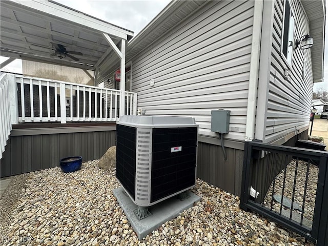 exterior details with cooling unit and a ceiling fan