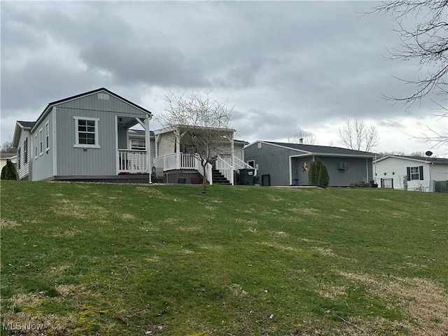 rear view of house with a lawn and a wooden deck