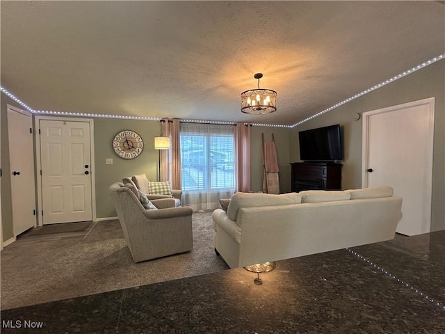 carpeted living room with a textured ceiling, lofted ceiling, and an inviting chandelier