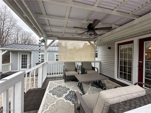 wooden terrace featuring an outdoor hangout area and a ceiling fan