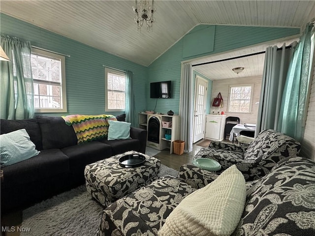 living area featuring a healthy amount of sunlight, wood finished floors, and vaulted ceiling