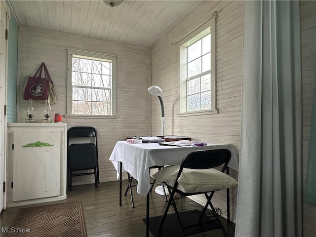dining room featuring hardwood / wood-style floors and wooden ceiling