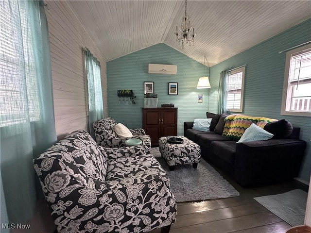living area featuring a notable chandelier, wood-type flooring, lofted ceiling, and a wall unit AC