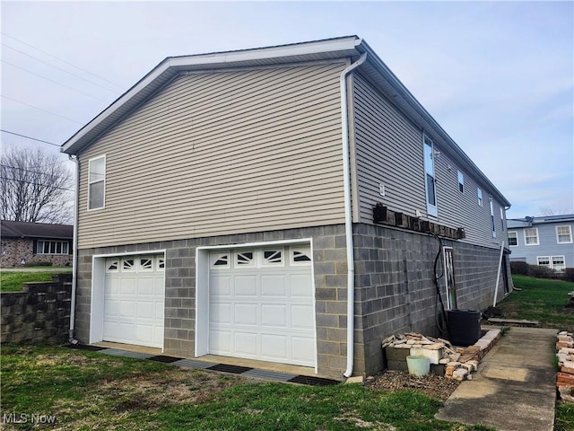 view of side of home with an attached garage