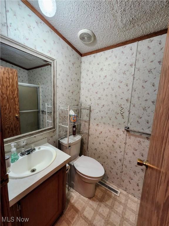 bathroom featuring tile patterned floors, visible vents, a stall shower, and wallpapered walls