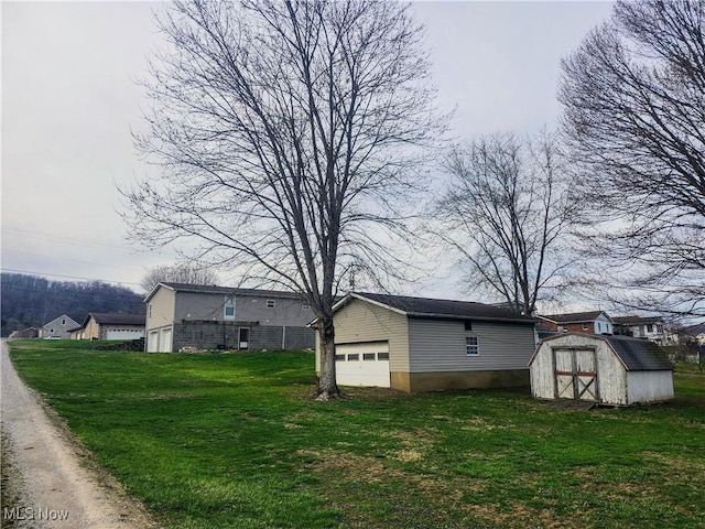 view of home's exterior with a storage unit, a yard, and an outbuilding