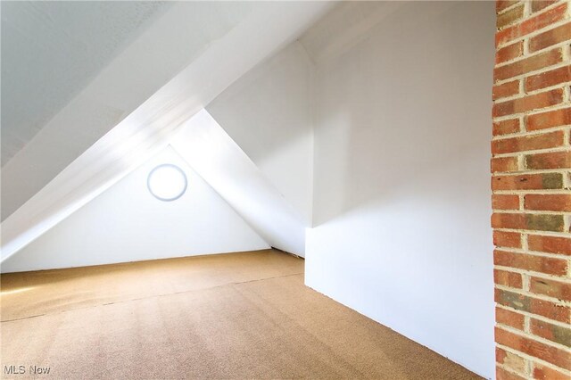 15921 Cloverside Ave, Cleveland, OH 44128 - bonus room with lofted ceiling, carpet, and brick wall