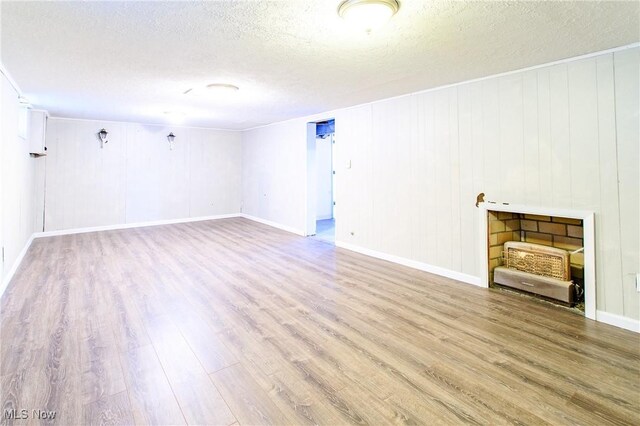 15921 Cloverside Ave, Cleveland, OH 44128 - unfurnished living room with baseboards, a textured ceiling, and wood finished floors