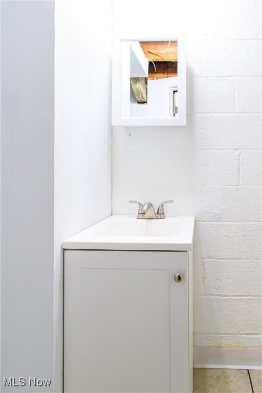 15921 Cloverside Ave, Cleveland, OH 44128 - bathroom featuring concrete block wall and vanity