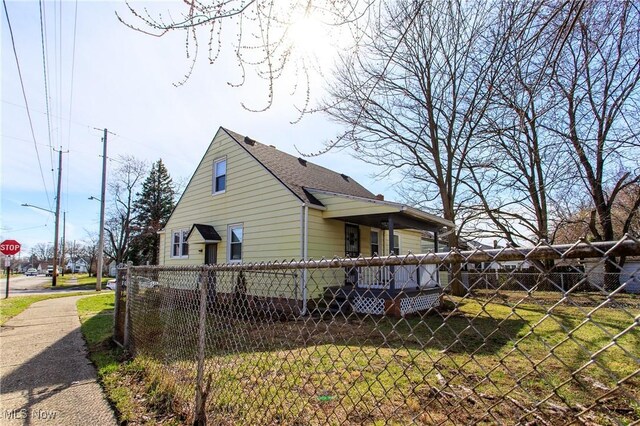 15921 Cloverside Ave, Cleveland, OH 44128 - view of side of property with a yard and fence