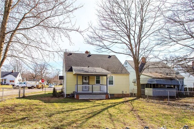 15921 Cloverside Ave, Cleveland, OH 44128 - rear view of property featuring covered porch, a chimney, a yard, and fence