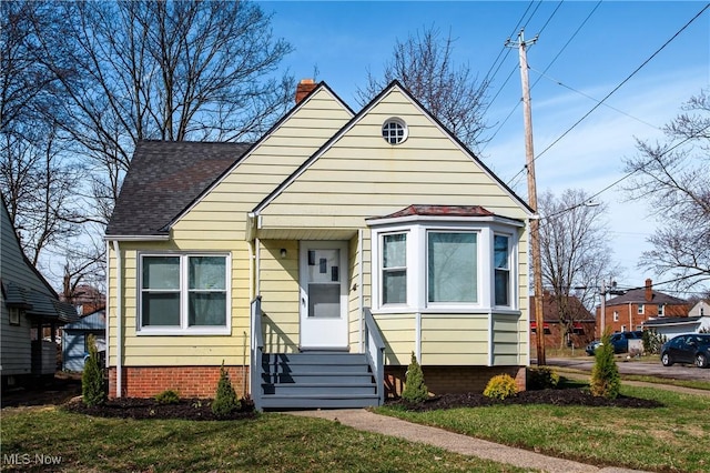 15921 Cloverside Ave, Cleveland, OH 44128 - bungalow-style home featuring entry steps, a chimney, a front lawn, and roof with shingles