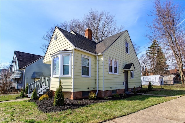 15921 Cloverside Ave, Cleveland, OH 44128 - view of property exterior featuring fence, a lawn, and a chimney