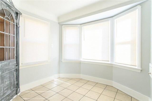 15921 Cloverside Ave, Cleveland, OH 44128 - spare room featuring light tile patterned floors, baseboards, and a healthy amount of sunlight