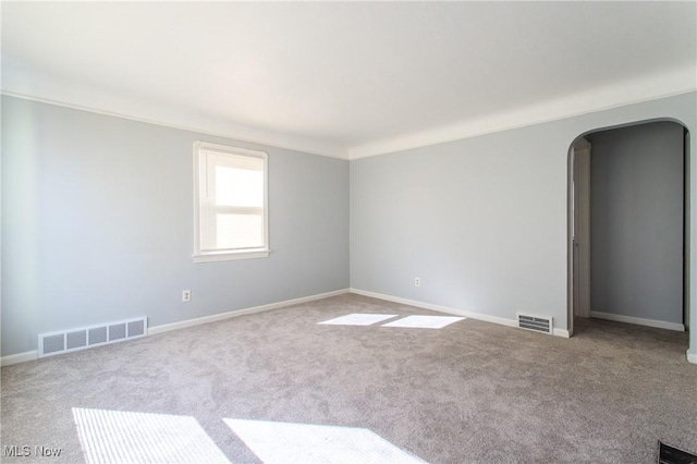 15921 Cloverside Ave, Cleveland, OH 44128 - carpeted empty room featuring arched walkways, visible vents, and baseboards