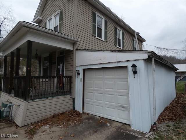 view of property exterior with a porch and an attached garage