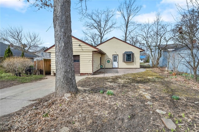 view of front of home featuring driveway, fence, and a patio area