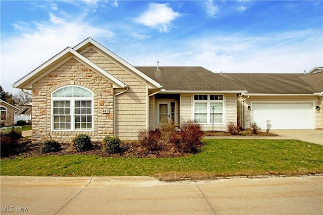 ranch-style house featuring stone siding, an attached garage, a front yard, driveway, and a shingled roof