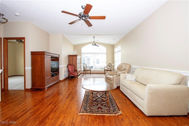 unfurnished living room with a ceiling fan, lofted ceiling, and wood finished floors
