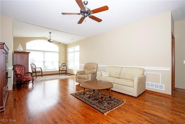 living area featuring a ceiling fan, wood finished floors, lofted ceiling, and visible vents