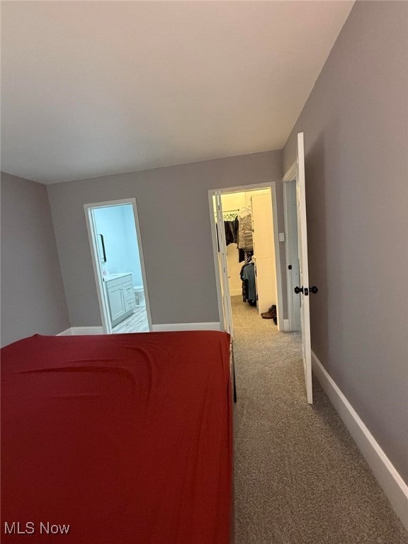 163 The Brooklands, Akron, OH 44305 - unfurnished bedroom featuring a walk in closet, carpet, baseboards, and ensuite bath