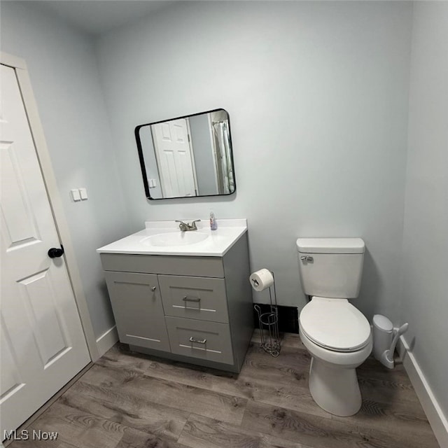 163 The Brooklands, Akron, OH 44305 - half bath with vanity, toilet, wood finished floors, and baseboards