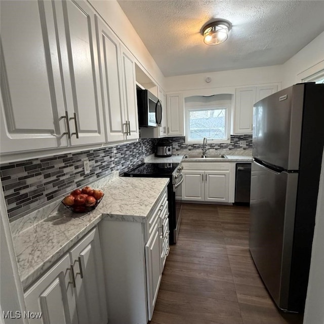 163 The Brooklands, Akron, OH 44305 - kitchen with appliances with stainless steel finishes, a sink, a textured ceiling, white cabinetry, and light countertops
