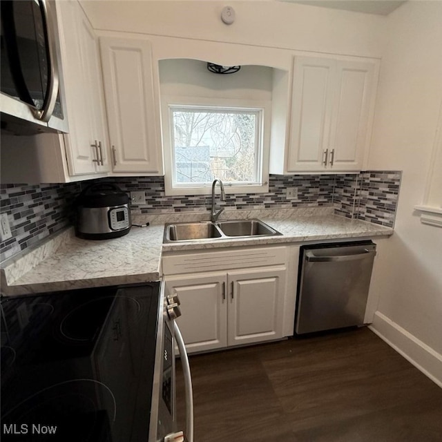 163 The Brooklands, Akron, OH 44305 - kitchen featuring appliances with stainless steel finishes, a sink, white cabinetry, dark wood-style flooring, and light countertops
