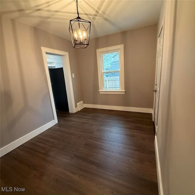 163 The Brooklands, Akron, OH 44305 - unfurnished room featuring a chandelier, dark wood-type flooring, and baseboards